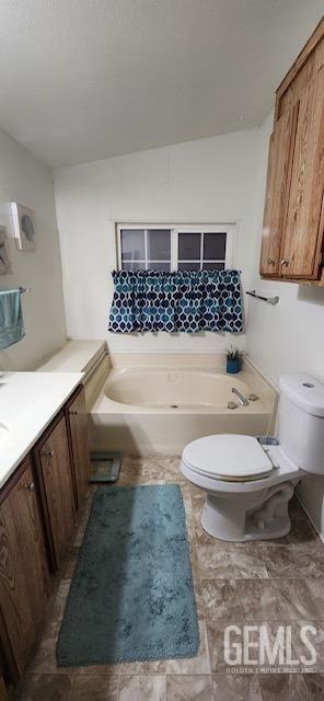 bathroom featuring a bathtub, vanity, and toilet