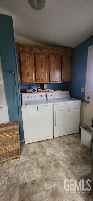 laundry room with cabinets and washing machine and dryer