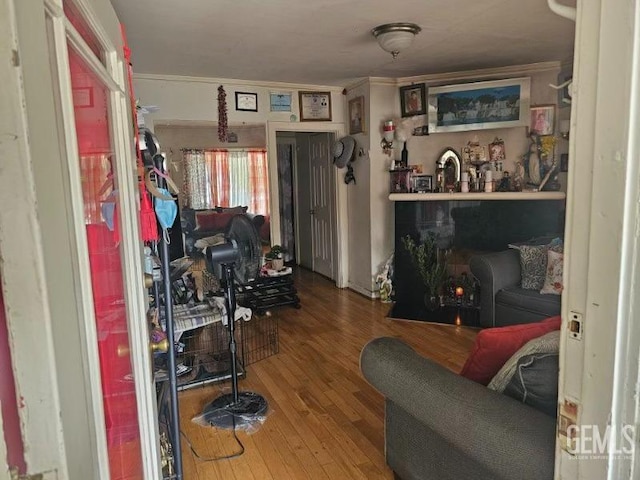 living room with hardwood / wood-style flooring and ornamental molding