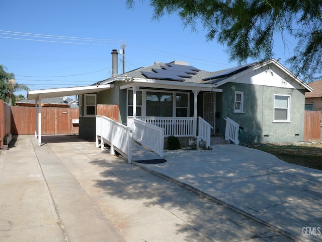 101 Oakdale Dr, Bakersfield, CA 93309 - bungalow with crawl space, an attached carport, solar panels, fence, and covered porch