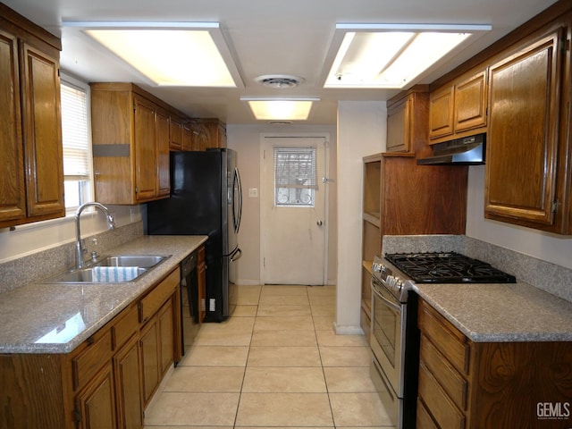 101 Oakdale Dr, Bakersfield, CA 93309 - kitchen with stainless steel range with gas stovetop, a sink, dishwasher, under cabinet range hood, and light tile patterned floors