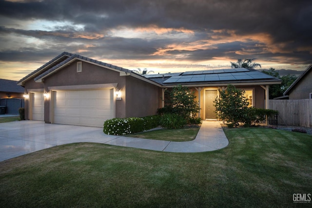 9900 Swansboro Way, Bakersfield, CA 93314 - single story home with an attached garage, solar panels, driveway, and stucco siding