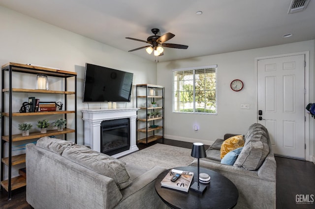 9900 Swansboro Way, Bakersfield, CA 93314 - living area featuring dark wood-type flooring, a ceiling fan, and baseboards