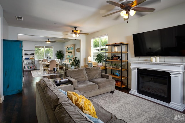 9900 Swansboro Way, Bakersfield, CA 93314 - living area with ceiling fan, plenty of natural light, and dark wood-style flooring