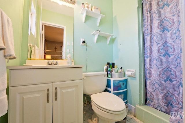 full bathroom with a stall shower, vanity, and toilet