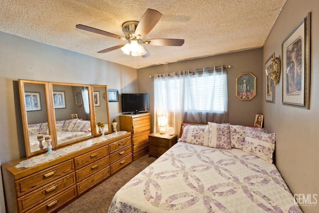 bedroom with a ceiling fan, dark carpet, and a textured ceiling