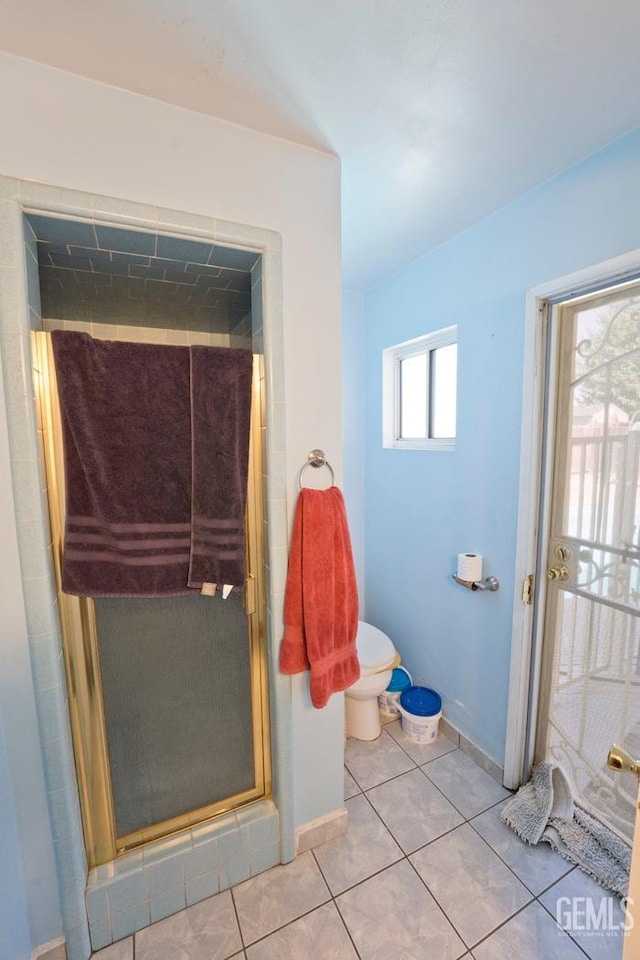 full bathroom with baseboards, a shower stall, toilet, and tile patterned floors