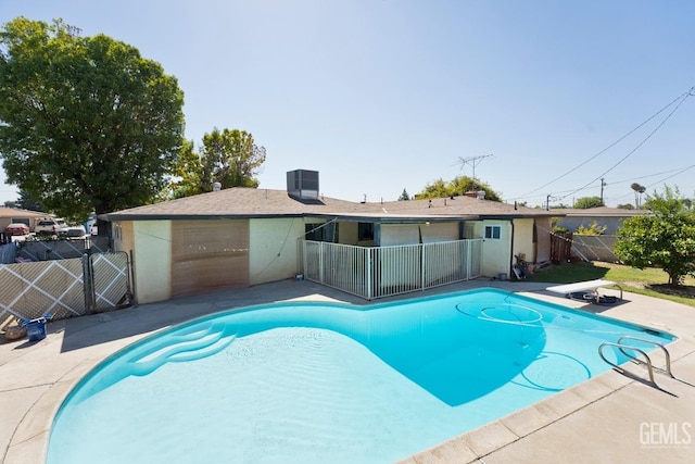 view of pool featuring fence, a diving board, and a fenced in pool