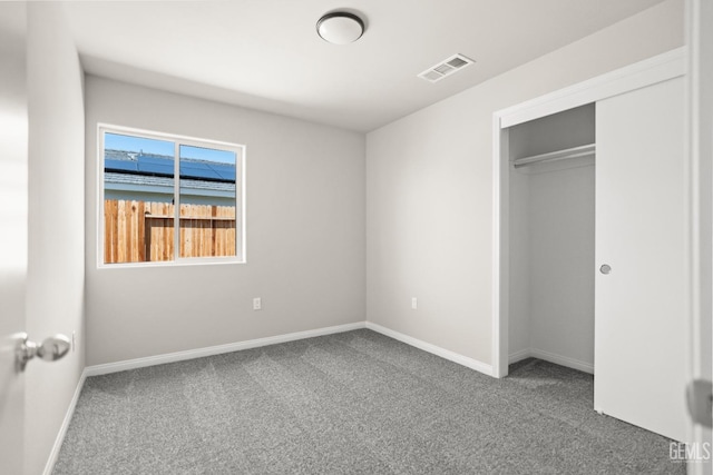 707 Poinsettia St, Bakersfield, CA 93307 - unfurnished bedroom with carpet floors, baseboards, and a closet