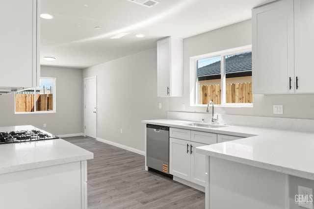 707 Poinsettia St, Bakersfield, CA 93307 - kitchen featuring stainless steel dishwasher, a sink, stovetop, light wood-style floors, and recessed lighting