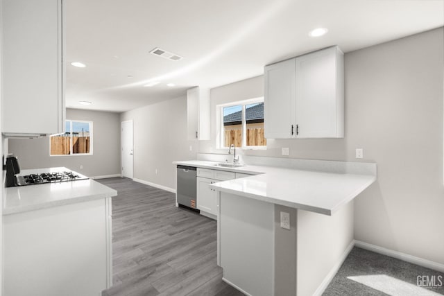 707 Poinsettia St, Bakersfield, CA 93307 - kitchen with baseboards, white cabinetry, a sink, stainless steel dishwasher, and light countertops
