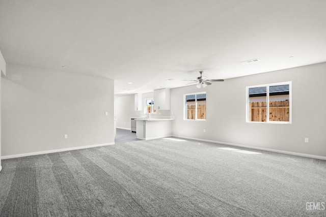 707 Poinsettia St, Bakersfield, CA 93307 - unfurnished living room with dark colored carpet, a ceiling fan, baseboards, and recessed lighting