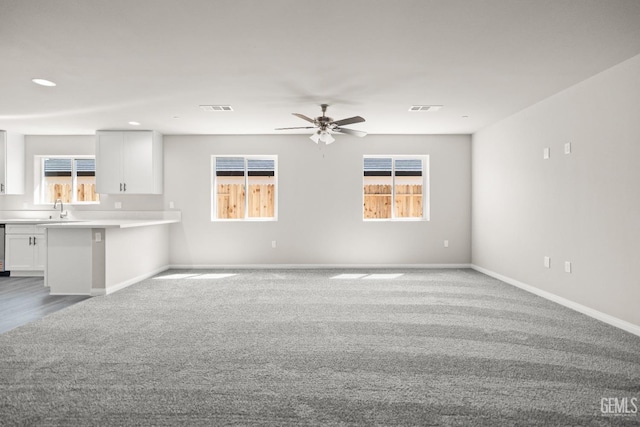707 Poinsettia St, Bakersfield, CA 93307 - unfurnished living room featuring carpet floors, a sink, baseboards, recessed lighting, and a ceiling fan