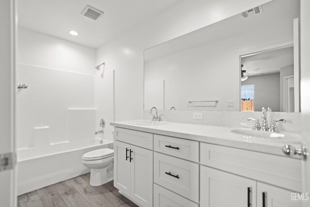 707 Poinsettia St, Bakersfield, CA 93307 - full bath with double vanity, wood finished floors, toilet,  shower combination, and a ceiling fan