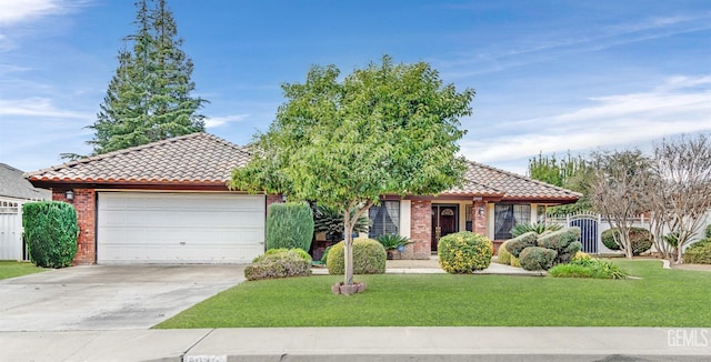 view of front of home with a garage and a front lawn