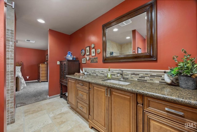 bathroom featuring tasteful backsplash, visible vents, baseboards, vanity, and recessed lighting