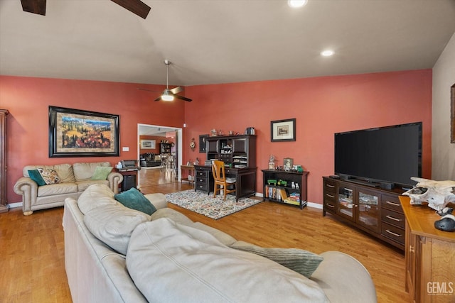 living area with baseboards, ceiling fan, wood finished floors, vaulted ceiling, and recessed lighting