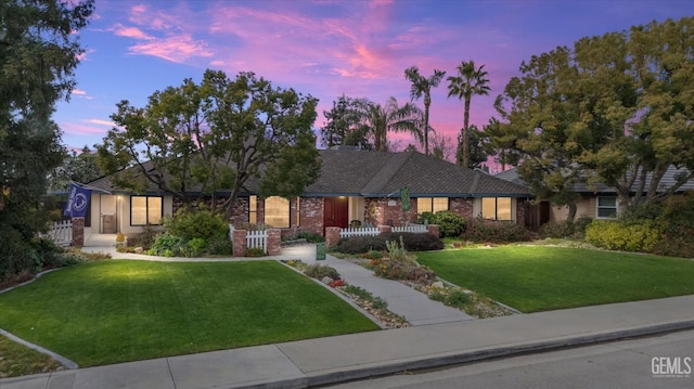 ranch-style house with a lawn