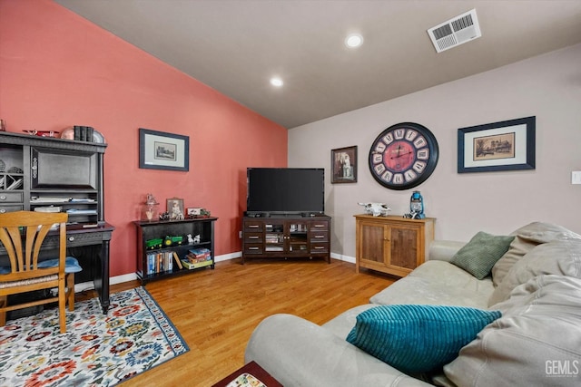 living room with baseboards, visible vents, wood finished floors, vaulted ceiling, and recessed lighting