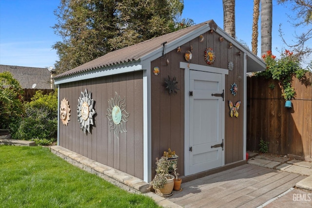 view of shed featuring fence