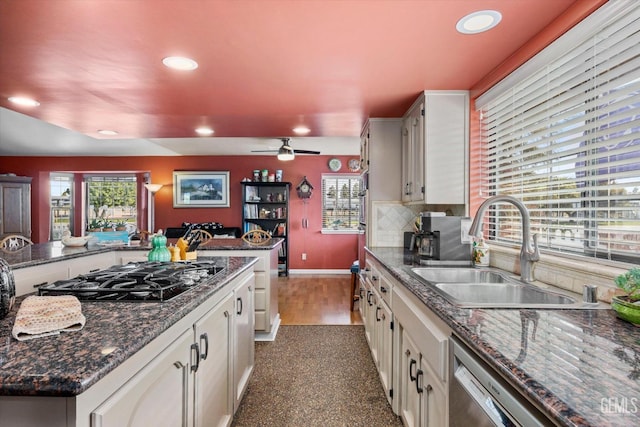 kitchen with black gas cooktop, recessed lighting, a sink, stainless steel dishwasher, and decorative backsplash