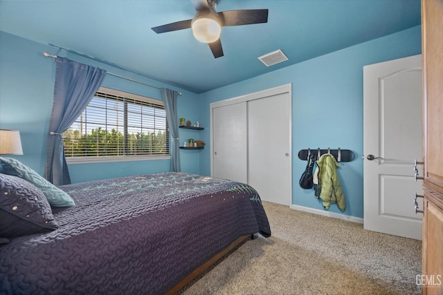 bedroom with carpet, a closet, visible vents, ceiling fan, and baseboards