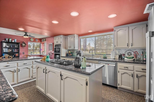 kitchen featuring a kitchen island, a sink, stainless steel appliances, backsplash, and recessed lighting