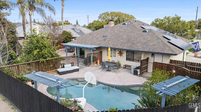 back of house featuring a shingled roof, a patio, fence, a pergola, and stucco siding