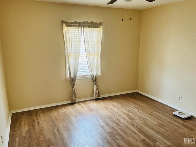 104 E Kern St, Taft, CA 93268 - empty room with a ceiling fan, wood finished floors, and baseboards