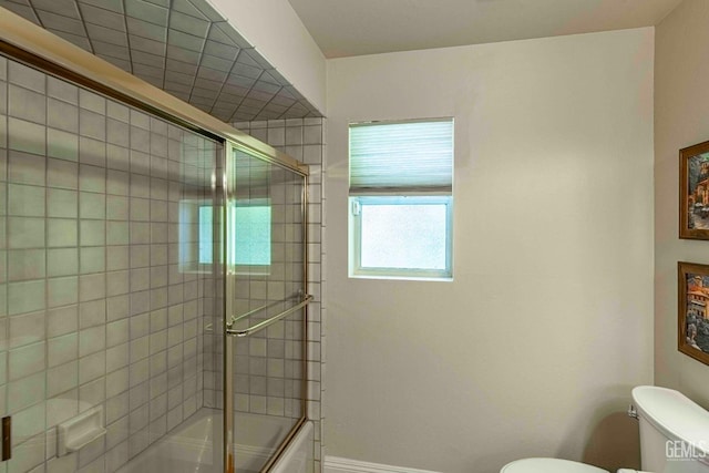 full bath with bath / shower combo with glass door and toilet