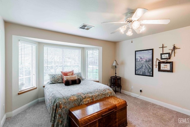 bedroom featuring visible vents, carpet floors, and multiple windows