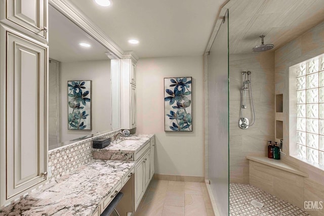 bathroom with recessed lighting, tiled shower, a healthy amount of sunlight, and vanity