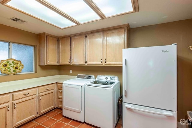 laundry room with light tile patterned floors, washing machine and dryer, visible vents, and laundry area