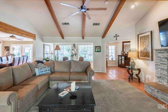 living room with beamed ceiling, a ceiling fan, visible vents, and plenty of natural light