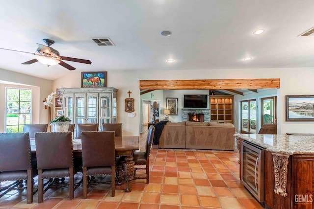 dining room with recessed lighting, visible vents, a wealth of natural light, and beverage cooler