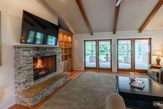 living room with vaulted ceiling with beams, tile patterned floors, a stone fireplace, baseboards, and french doors