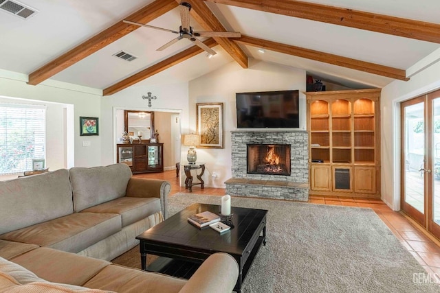 tiled living room featuring visible vents, lofted ceiling with beams, a ceiling fan, and a stone fireplace