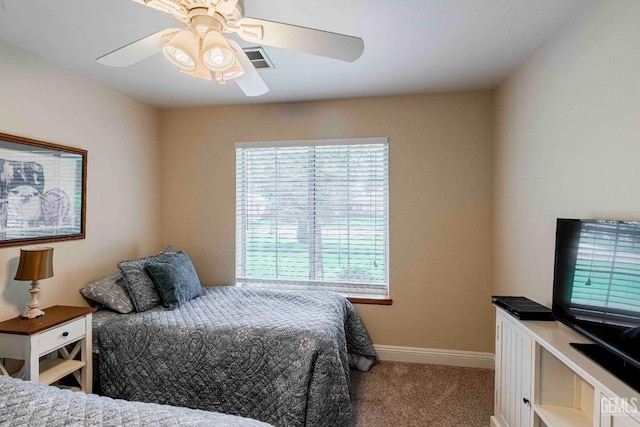 bedroom featuring a ceiling fan, visible vents, carpet floors, and baseboards