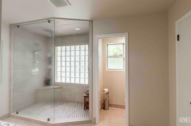 full bath with tile patterned floors, visible vents, a shower stall, and baseboards