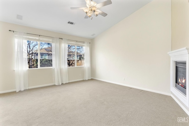 unfurnished living room with ceiling fan, lofted ceiling, and light carpet