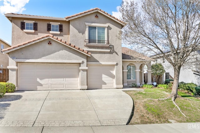 mediterranean / spanish-style home with a garage and a front lawn