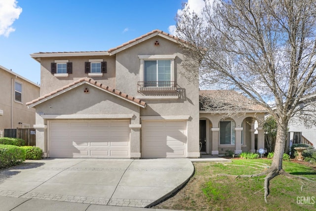 mediterranean / spanish-style house featuring a garage and a front yard