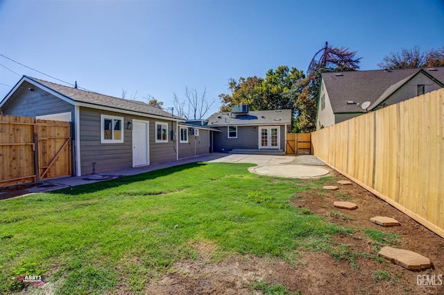 back of house with a patio area and a yard