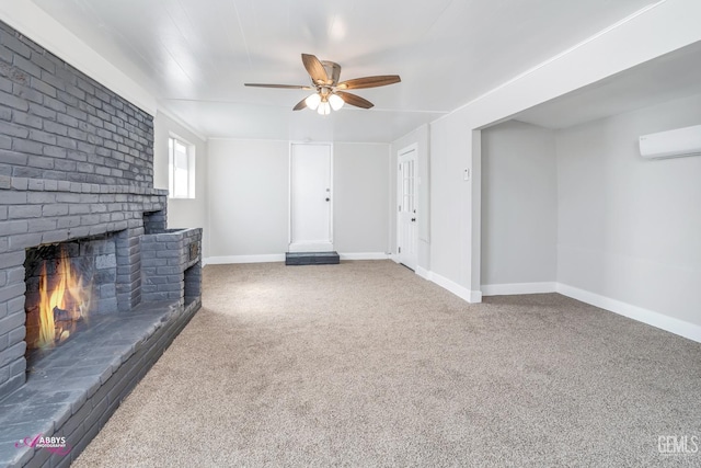 unfurnished living room featuring a brick fireplace, a wall unit AC, ceiling fan, and carpet flooring