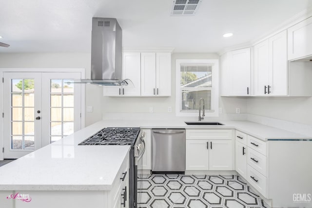 kitchen featuring ventilation hood, appliances with stainless steel finishes, sink, and white cabinetry