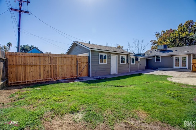 back of house featuring a lawn, cooling unit, a patio area, and french doors