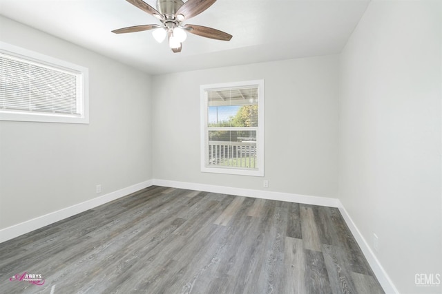 spare room featuring ceiling fan and dark hardwood / wood-style flooring