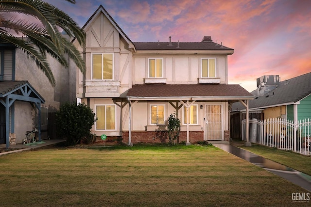 tudor-style house with a yard