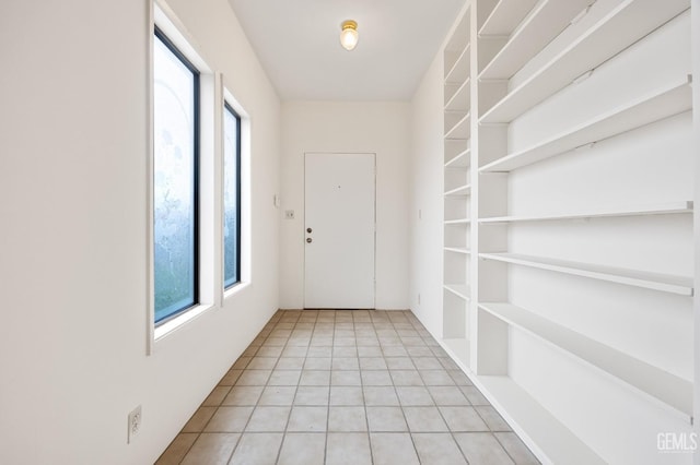 doorway to outside featuring plenty of natural light and light tile patterned flooring