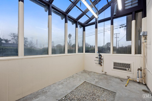 unfurnished sunroom featuring heating unit